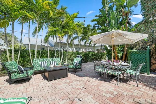 a living room with furniture rug and a potted plant