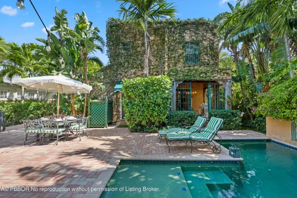 a bedroom with a bed and a lamp on a dresser