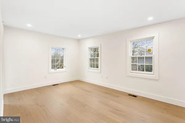 a view of staircase with wooden floor and white walls