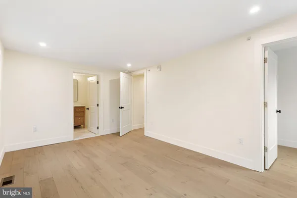a view of white house with a yard and potted plants
