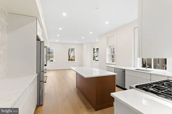 a kitchen with a sink appliances and cabinets