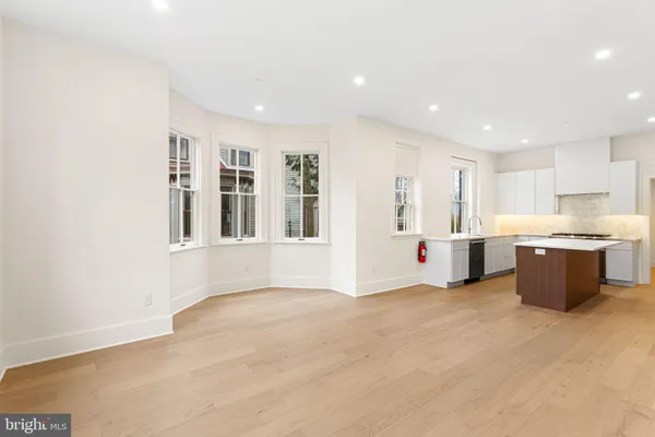 a view of kitchen with stainless steel appliances granite countertop a sink and cabinets