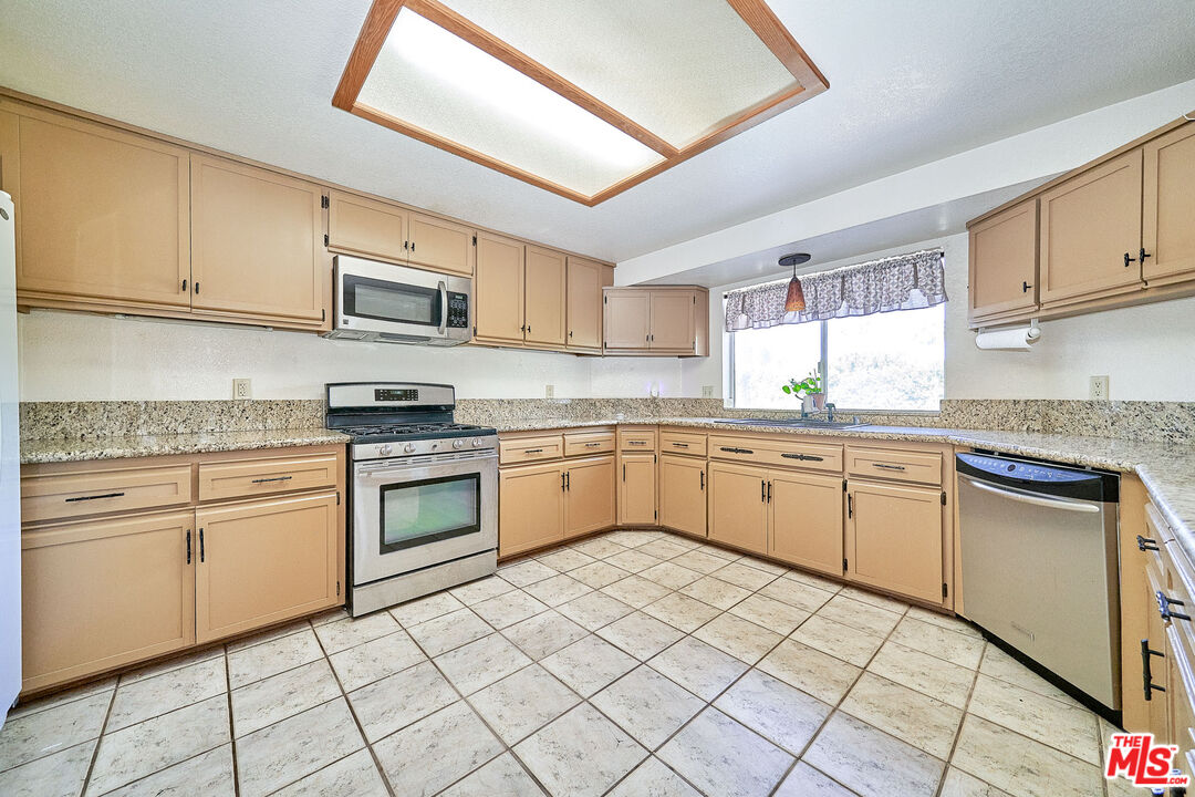 68920 Minerva Road Cathedral City, CA 92234 - Photo 11 of 49 a kitchen with a sink cabinets and window