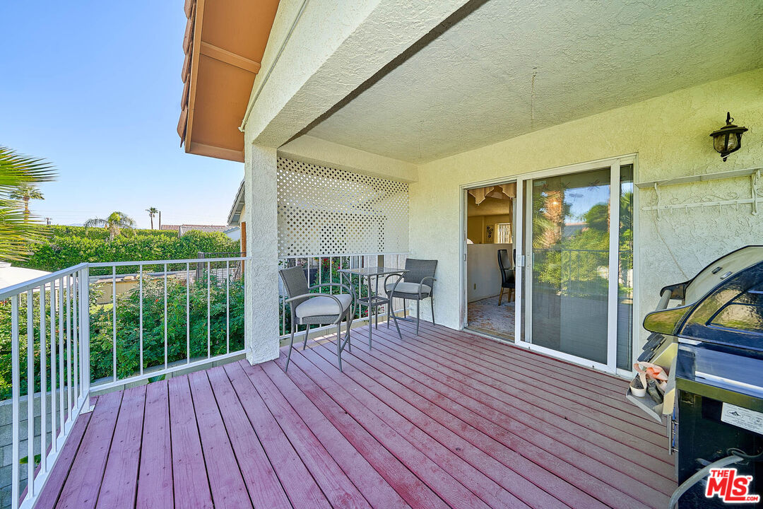 68920 Minerva Road Cathedral City, CA 92234 - Photo 17 of 49 a balcony with wooden floor table and chairs