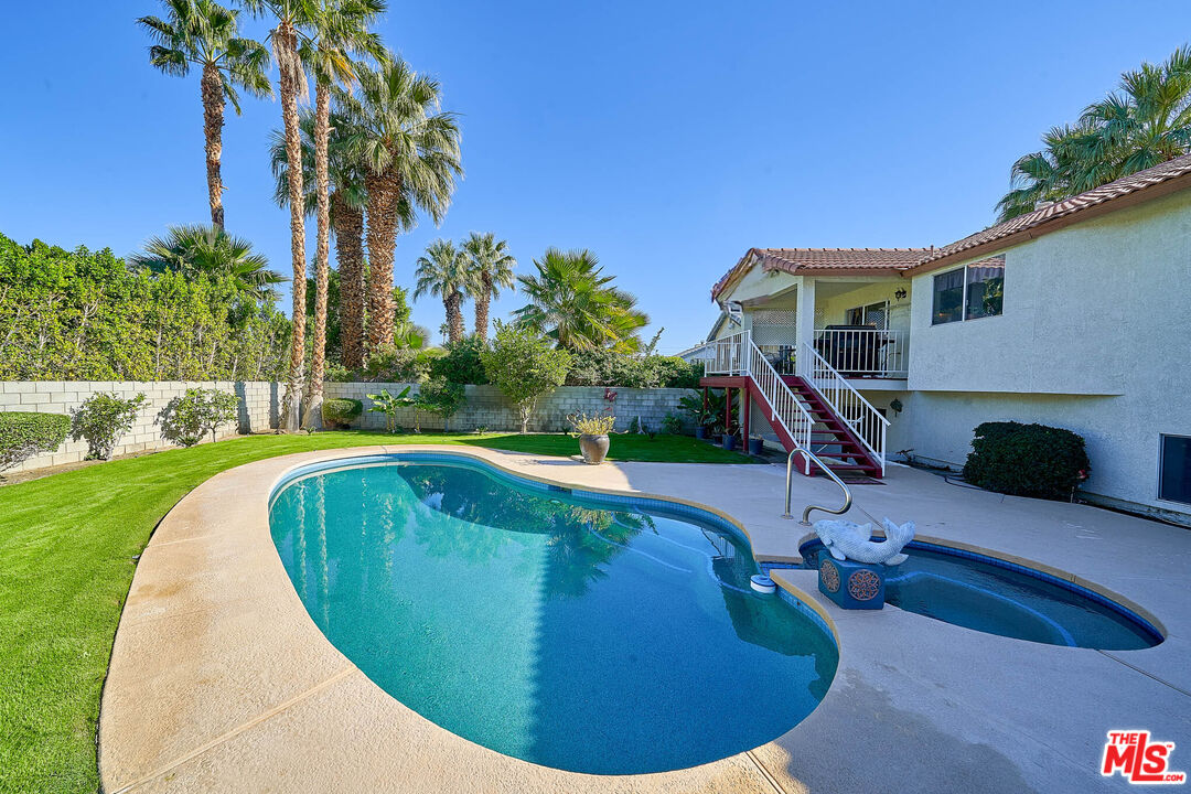 68920 Minerva Road Cathedral City, CA 92234 - Photo 19 of 49 a view of a swimming pool with a yard and palm trees