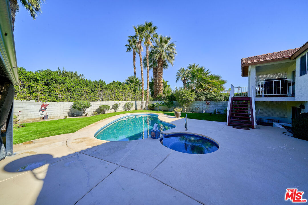 68920 Minerva Road Cathedral City, CA 92234 - Photo 20 of 49 a swimming pool with outdoor seating and yard