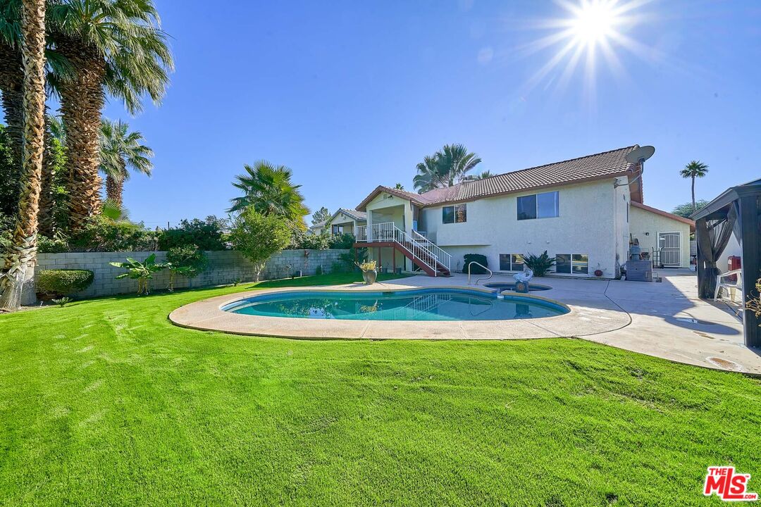 68920 Minerva Road Cathedral City, CA 92234 - Photo 23 of 49 a view of a house with pool and a yard