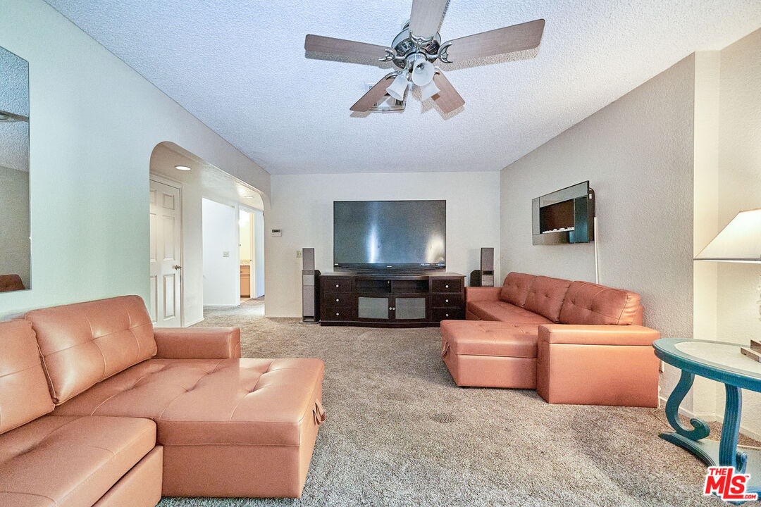 68920 Minerva Road Cathedral City, CA 92234 - Photo 27 of 49 a living room with furniture a couch and a chandelier