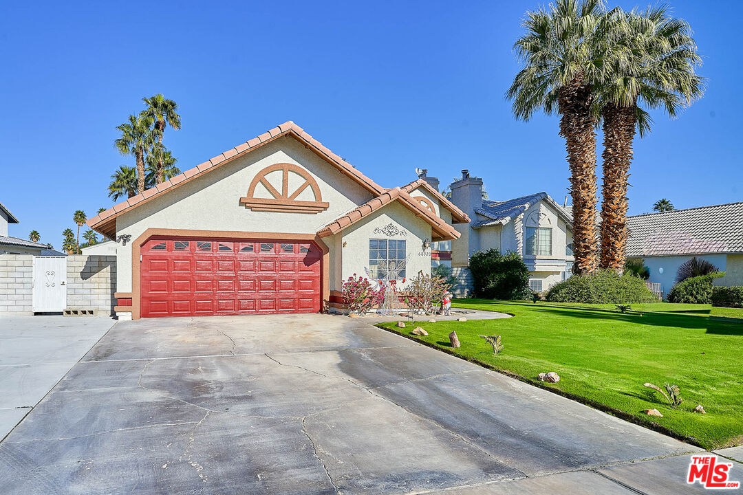 68920 Minerva Road Cathedral City, CA 92234 - Photo 3 of 49 a view of a house with a yard and potted plants