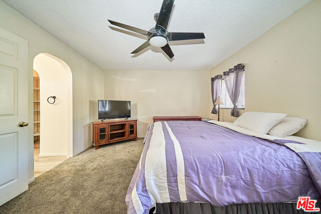 68920 Minerva Road Cathedral City, CA 92234 - Photo 31 of 49 a bedroom with a bed and a television