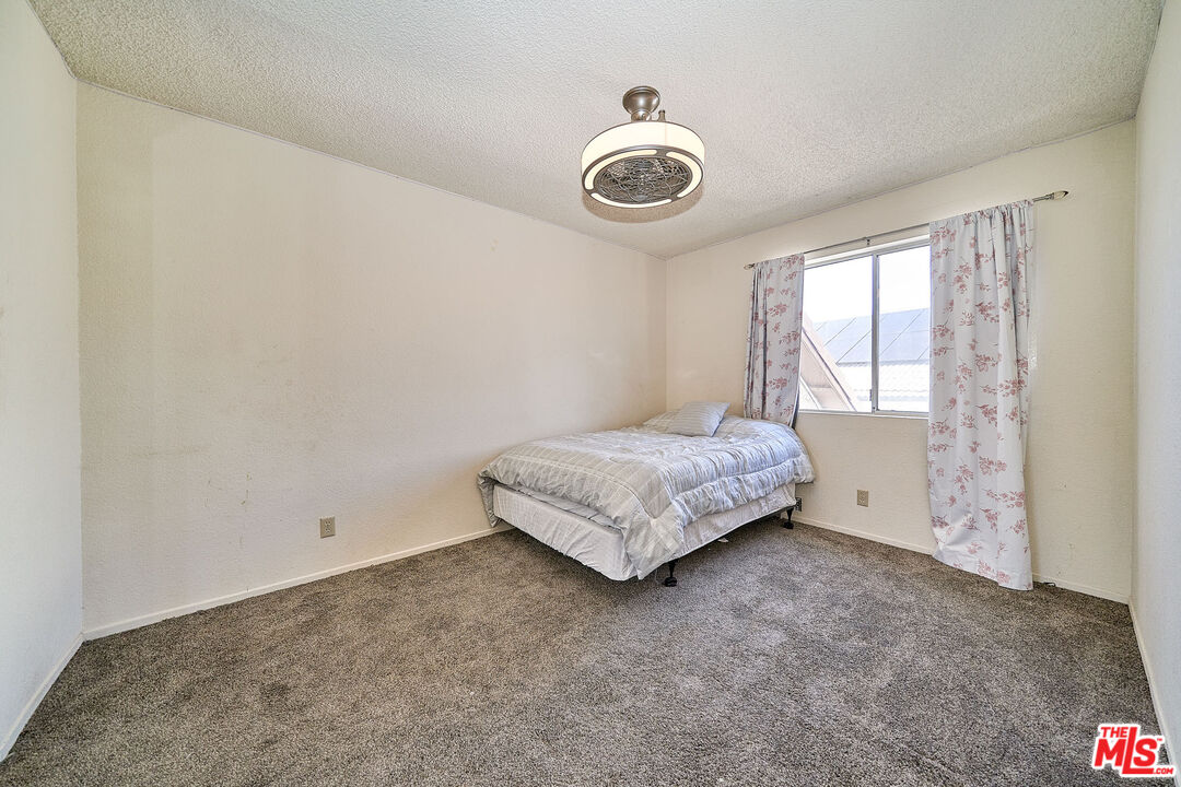 68920 Minerva Road Cathedral City, CA 92234 - Photo 40 of 49 a bedroom with a bed and a window