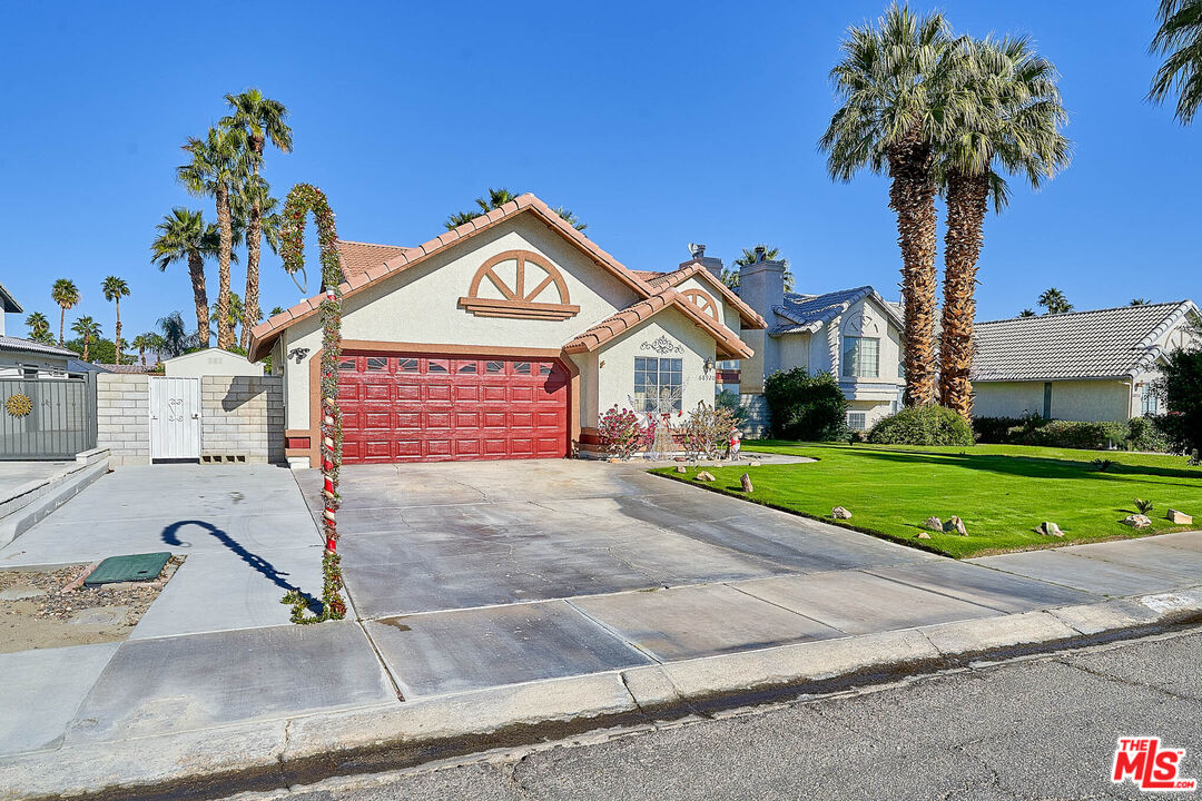 68920 Minerva Road Cathedral City, CA 92234 - Photo 4 of 49 a front view of a house with garden