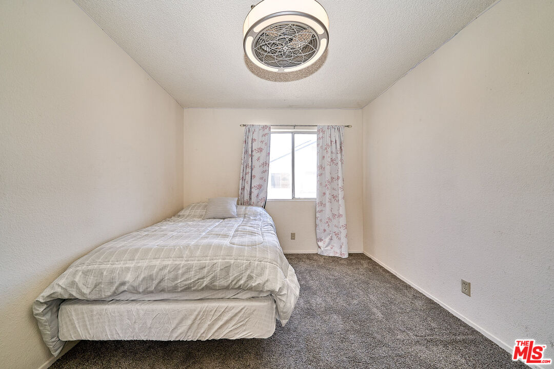 68920 Minerva Road Cathedral City, CA 92234 - Photo 41 of 49 a bedroom with a bed and a window