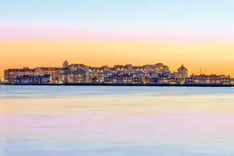 a front view of a building with tree s