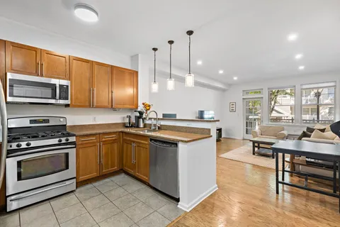 a kitchen with stainless steel appliances granite countertop a stove and a sink