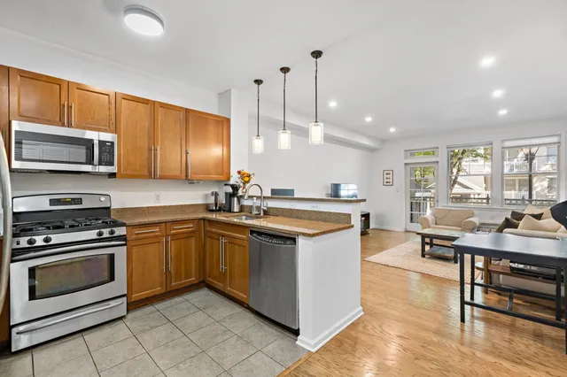 a kitchen with stainless steel appliances granite countertop a stove and a sink