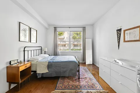 a bed room with a bed and a window