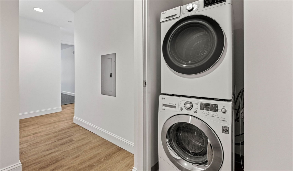 99 Kneeland Street, Unit 1001 Boston, MA 02111 - Photo 7 of 15 a view of a hallway with washer and dryer