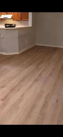 a view of kitchen with granite countertop cabinets and sink