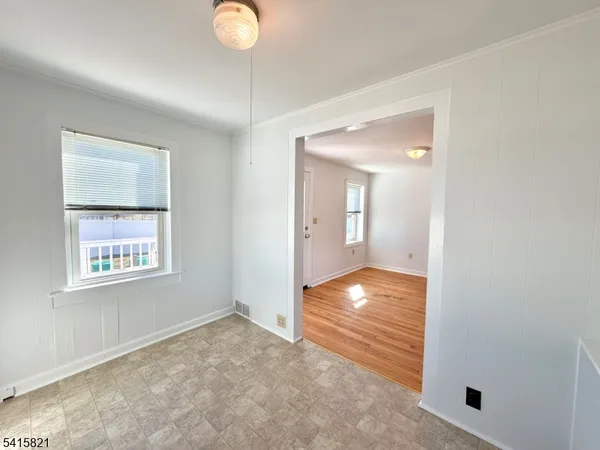 a kitchen with stainless steel appliances a refrigerator sink and wooden floor