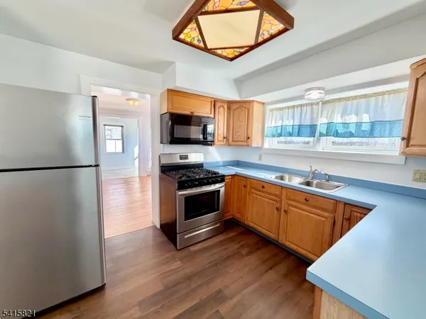 a view of a hallway with wooden floor and closet