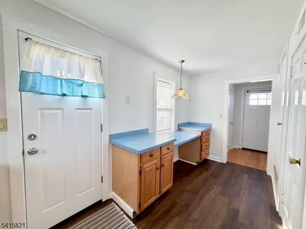 a view of a room with wooden floor