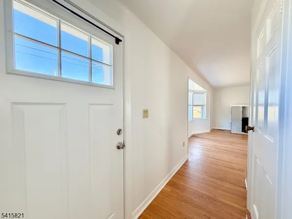 a view of empty room with window and ceiling fan