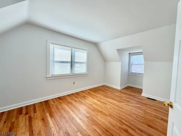 a view of room with wooden floor