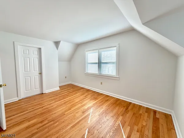 a front view of a house with a yard and lake view