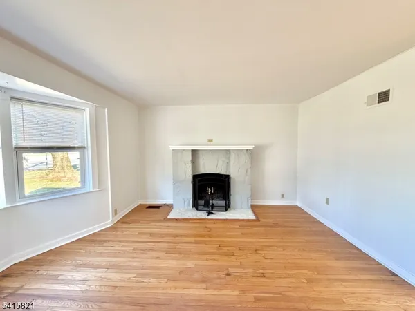 wooden floor in an empty room with a fireplace