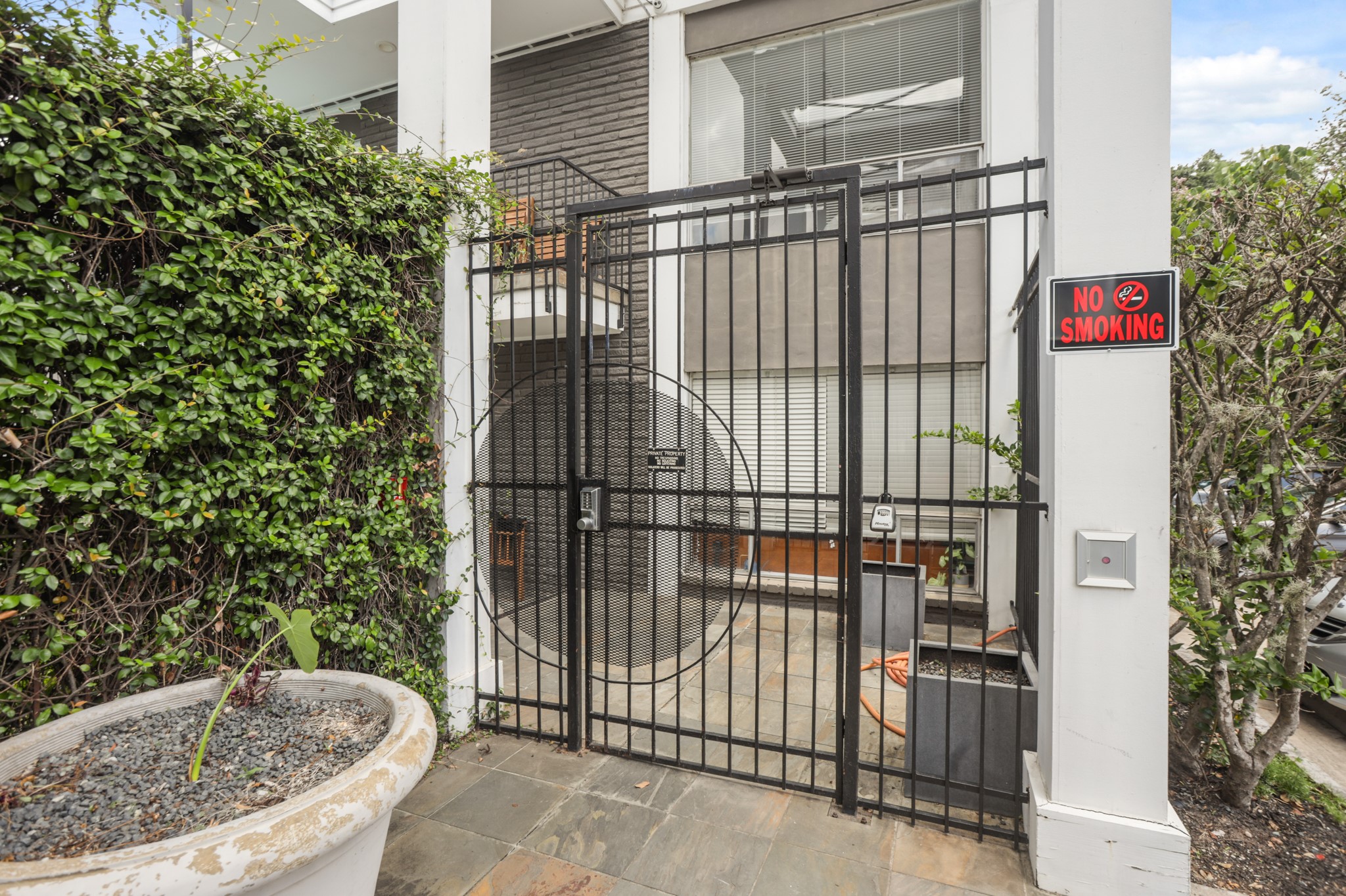 3602 Garrott Street, Unit 12 Houston, TX 77006 - Photo 2 of 34 Access is restricted with gates and keypads. There are cameras for extra security.