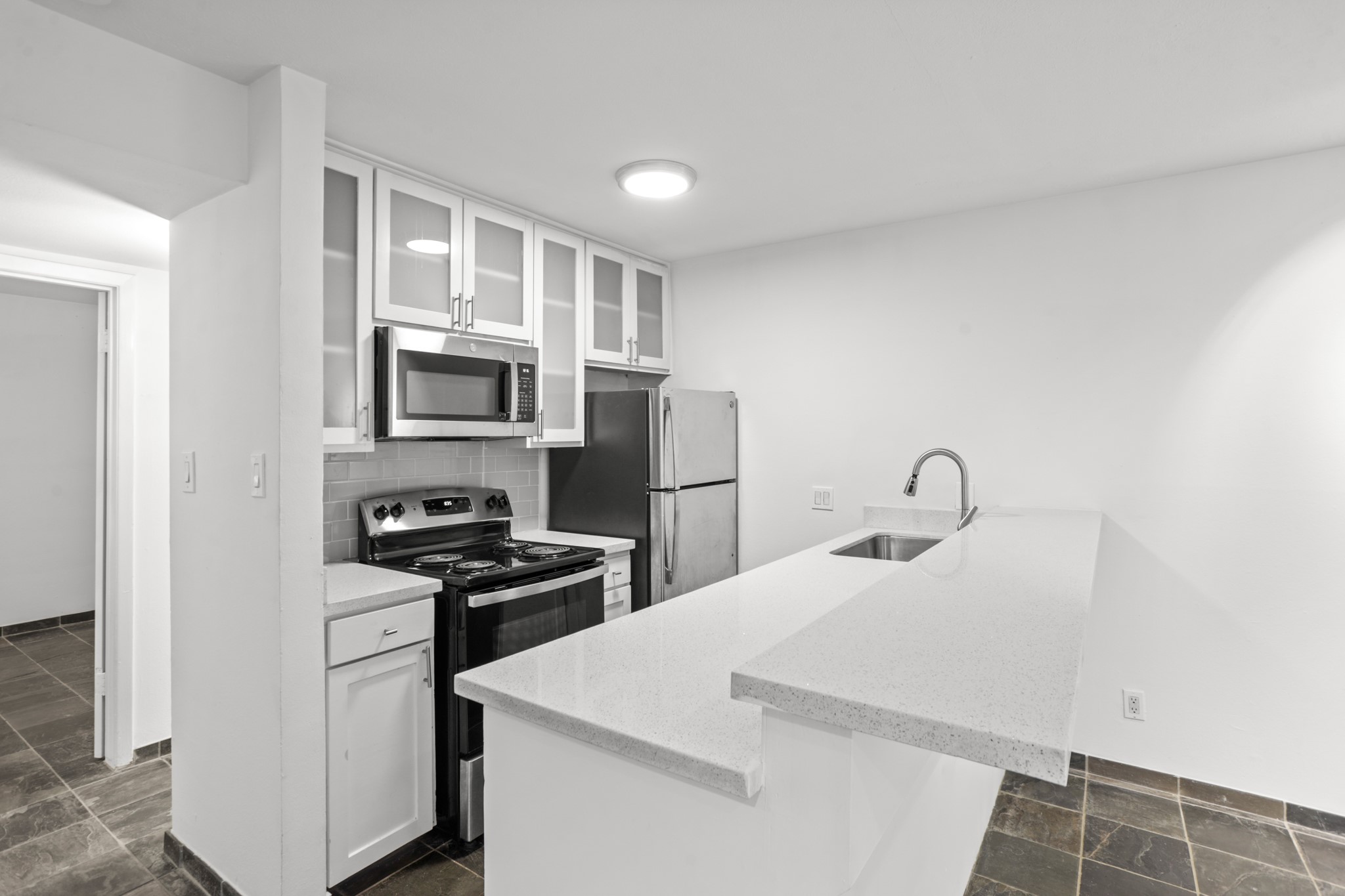 3602 Garrott Street, Unit 12 Houston, TX 77006 - Photo 6 of 34 The kitchen has a full sized oven, microwave and refrigerator and garbage disposal.