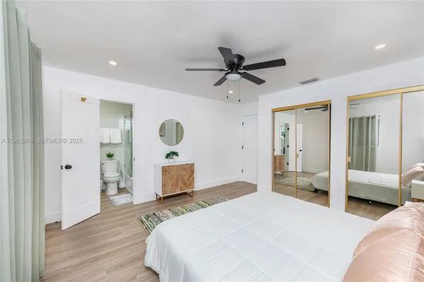 a bedroom with a bed and a large mirror