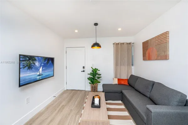 a living room with furniture flowerpot and flower pot
