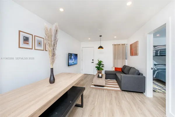 a living room with furniture and wooden floor