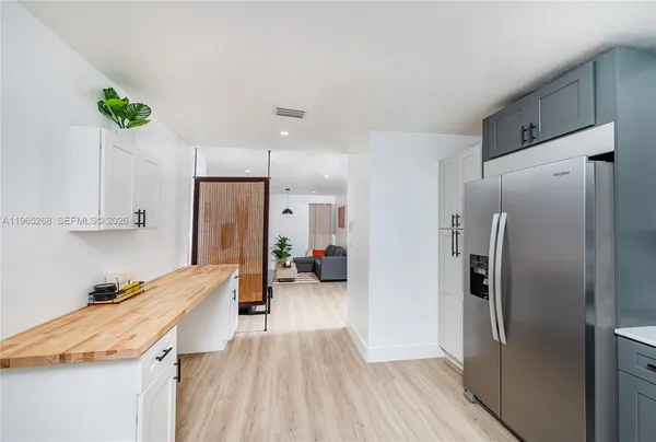 a kitchen with stainless steel appliances granite countertop a refrigerator and a sink