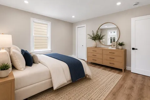 a bedroom with a bed and a dresser