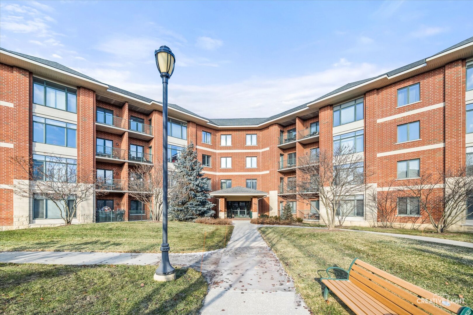a front view of a building with a garden