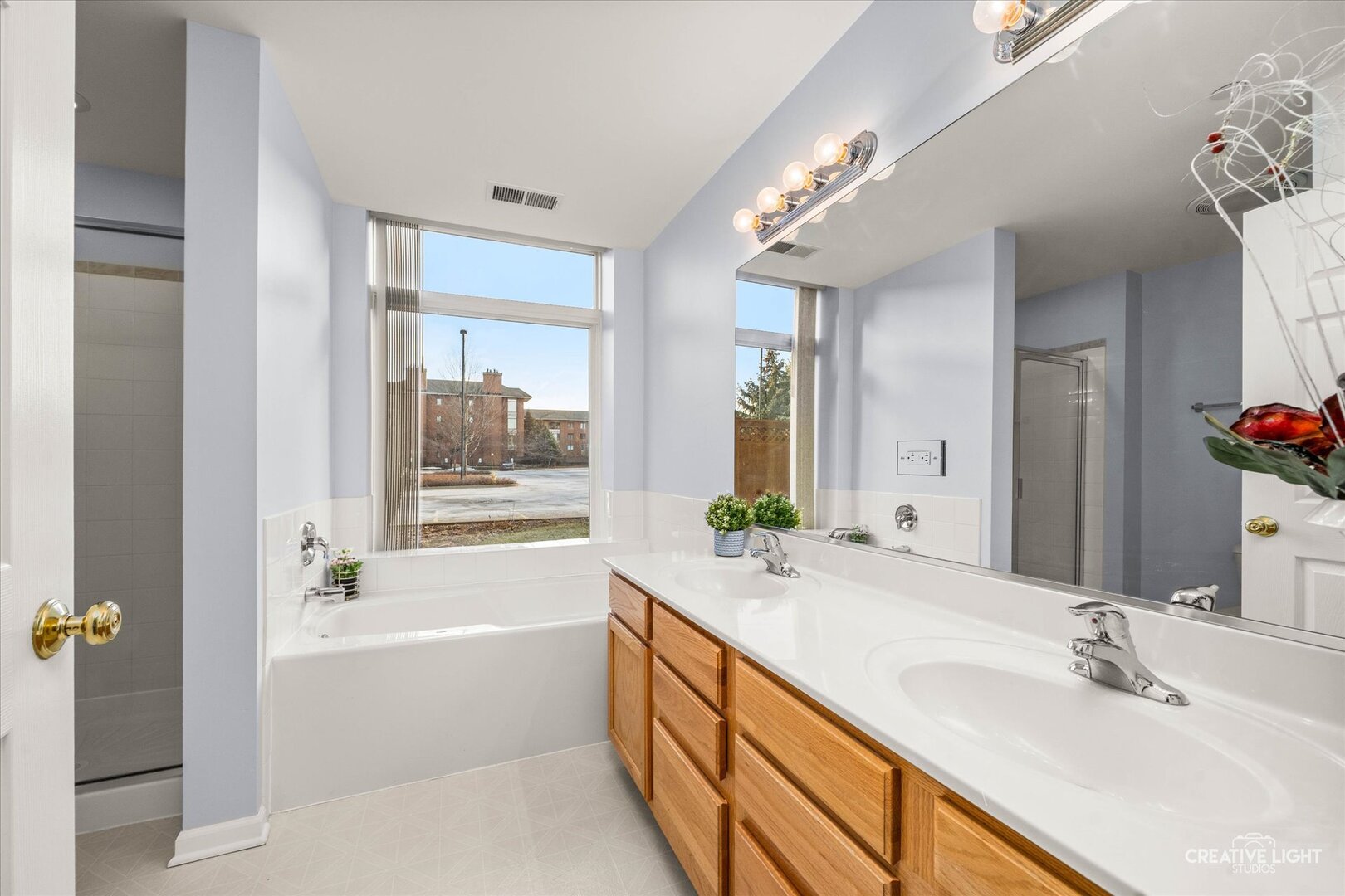 845 East 22nd Street, Unit B115 Lombard, IL 60148 - Photo 12 of 17 a bathroom with a granite countertop tub sink and mirror