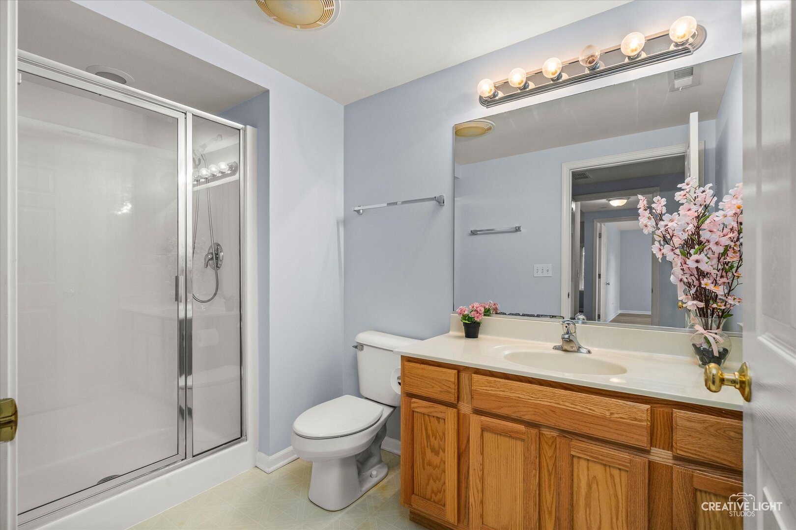 845 East 22nd Street, Unit B115 Lombard, IL 60148 - Photo 14 of 17 a bathroom with a sink a toilet and shower