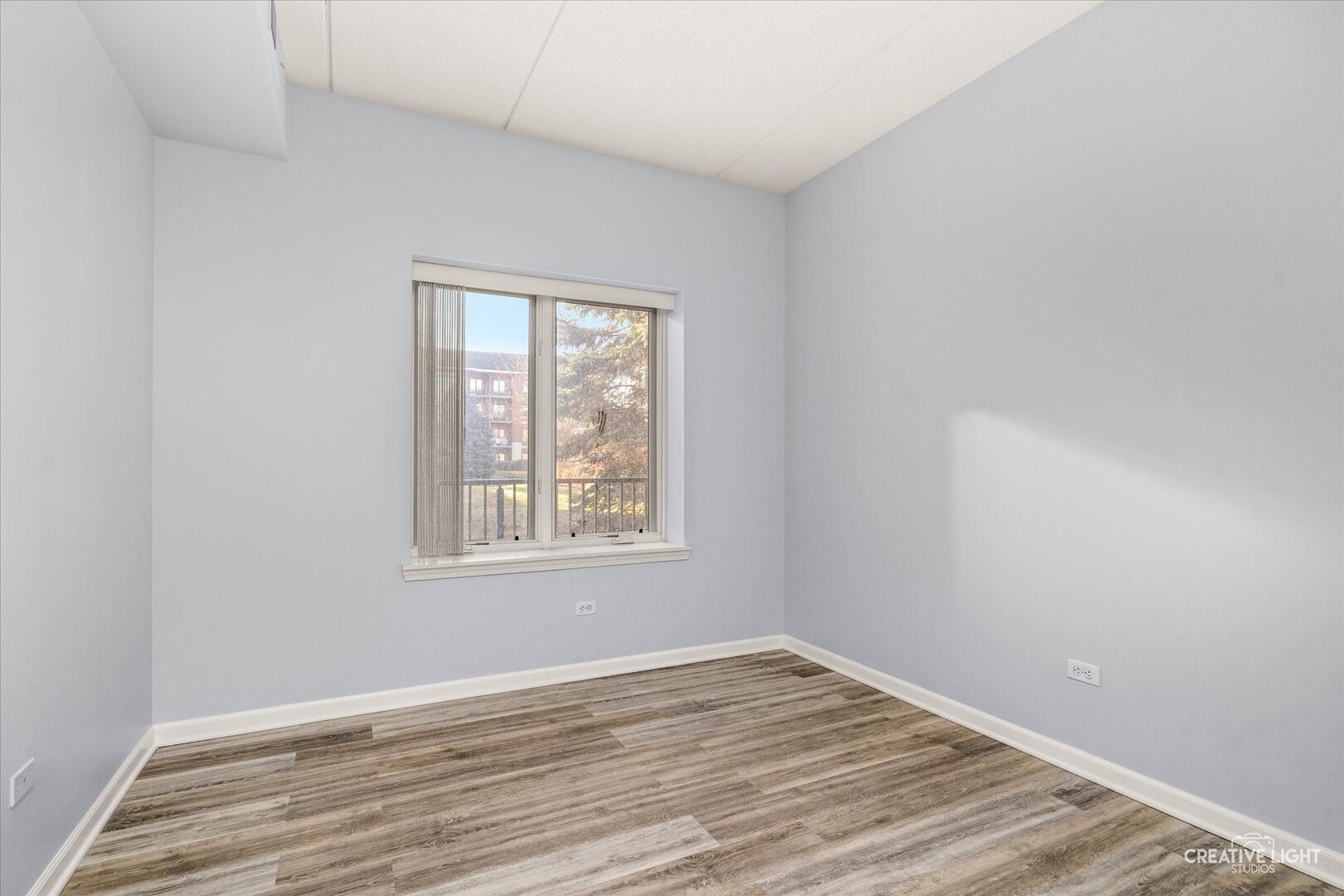 845 East 22nd Street, Unit B115 Lombard, IL 60148 - Photo 15 of 17 an empty room with wooden floor and windows