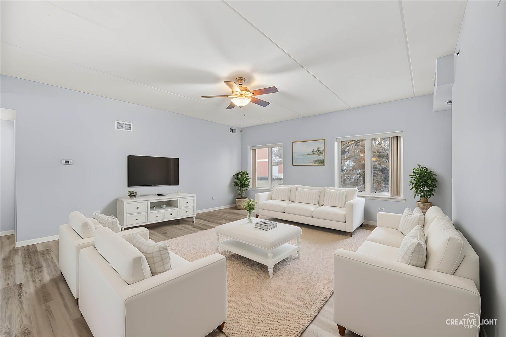 845 East 22nd Street, Unit B115 Lombard, IL 60148 - Photo 3 of 17 a living room with furniture and a flat screen tv