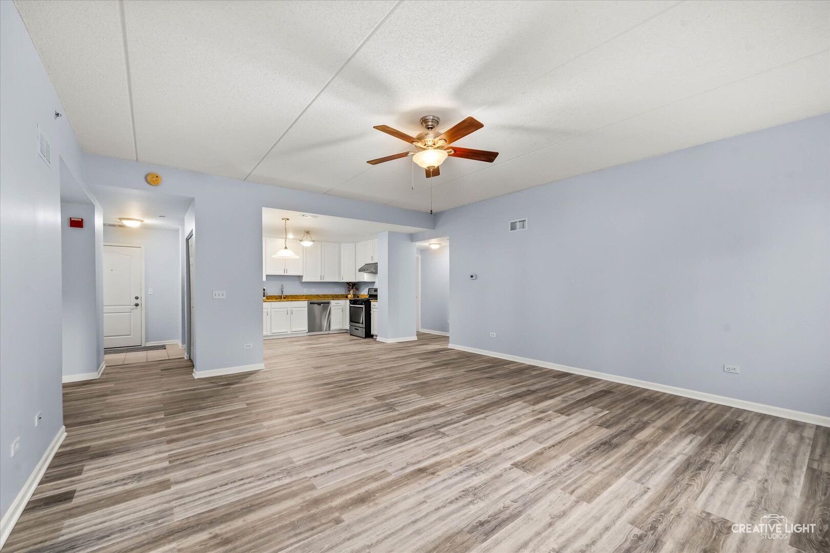 845 East 22nd Street, Unit B115 Lombard, IL 60148 - Photo 6 of 17 a view of an empty room with window and a ceiling fan