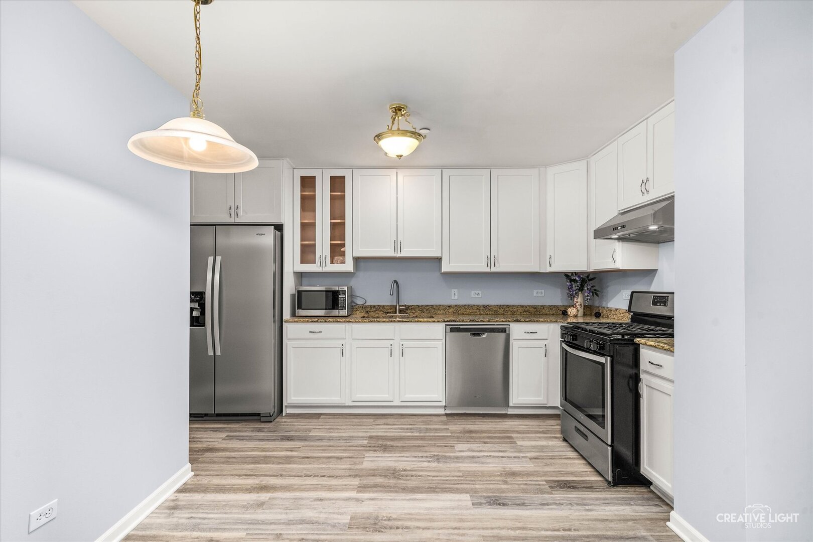 845 East 22nd Street, Unit B115 Lombard, IL 60148 - Photo 7 of 17 a kitchen with stainless steel appliances granite countertop a stove a refrigerator and a microwave