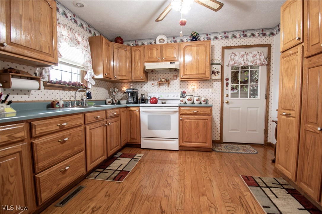 65525 Larrick Ridge Road Cambridge, OH 43725 - Photo 17 of 40 Kitchen with light wood floors, beautiful kitchen cabinets, with an electric range
