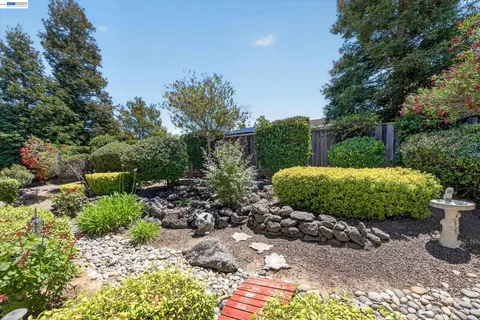 a view of a patio with table and chairs and potted plants