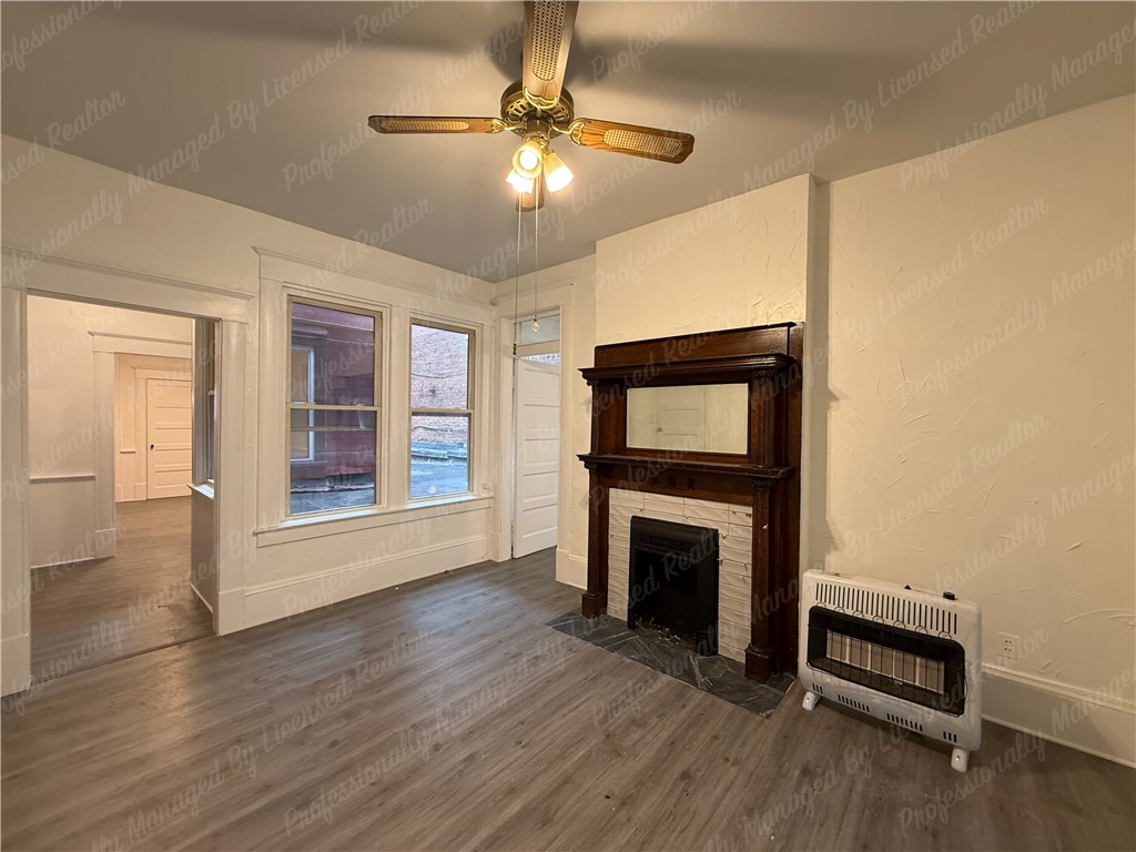 44 West High Street, Unit B Springfield, OH 45502 - Photo 15 of 31 This inviting space features classic design elements and durable flooring, creating a cozy and functional living area.