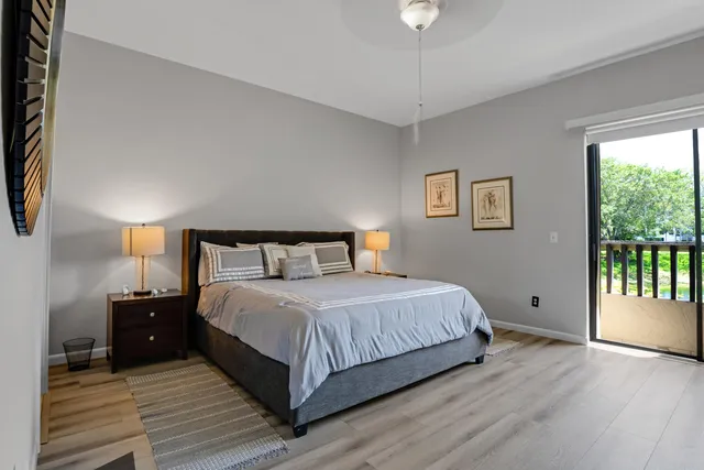 a bedroom with a bed and a large window