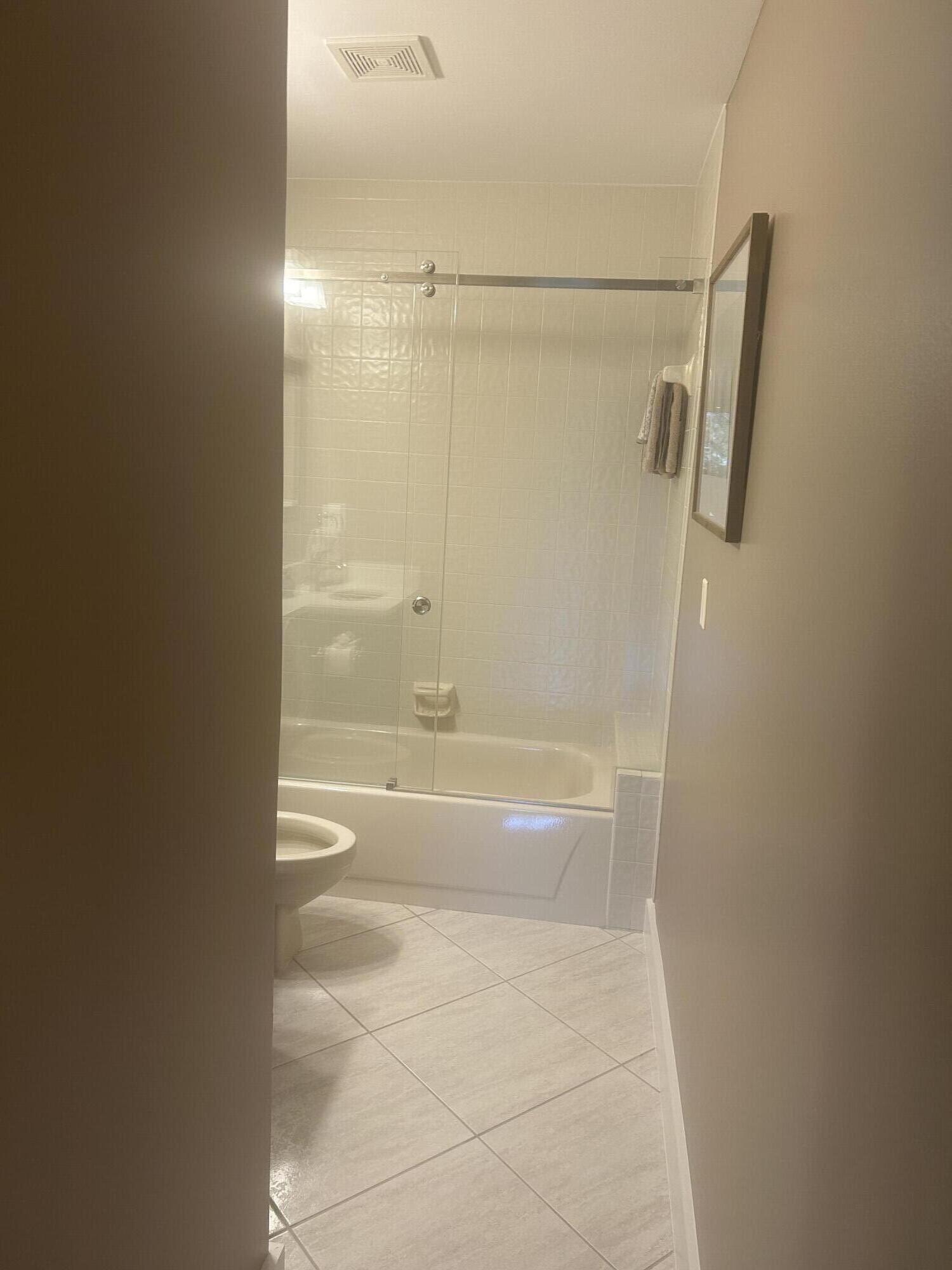 7472 La Paz Boulevard, Unit 102 Boca Raton, FL 33433 - Photo 11 of 14 a bathroom with a bathtub