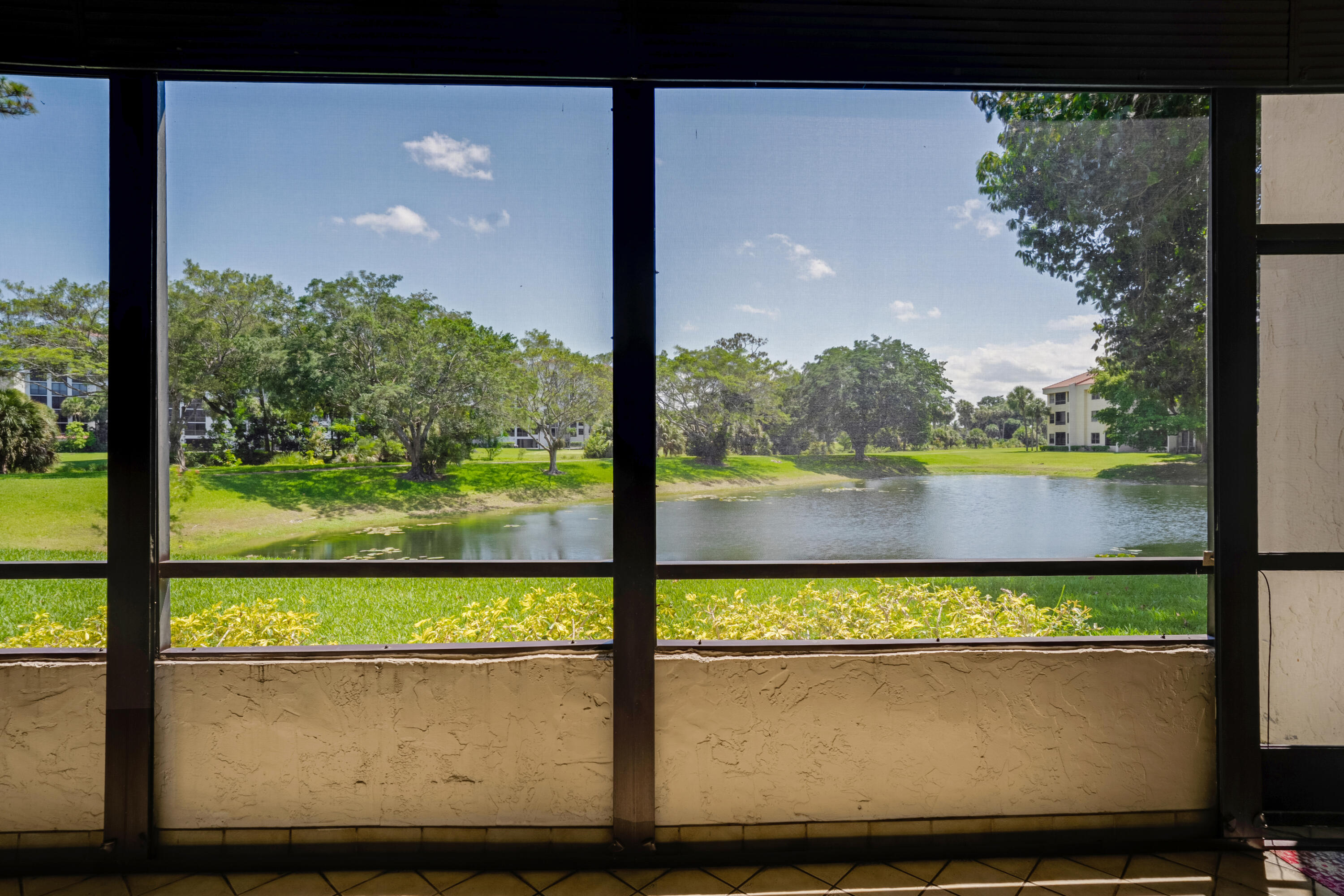7472 La Paz Boulevard, Unit 102 Boca Raton, FL 33433 - Photo 2 of 14 a view of lake from a balcony